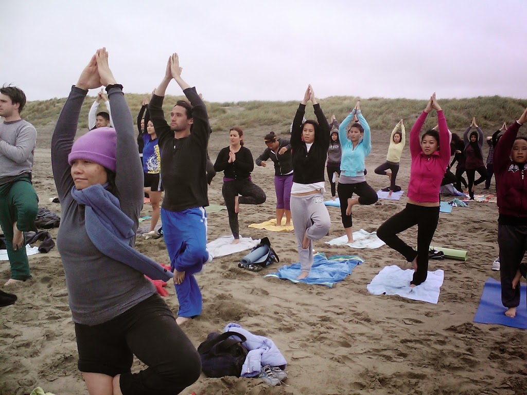 Yoga Students doing yoga outdoors on beach