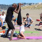 Yoga teacher adjust yoga student