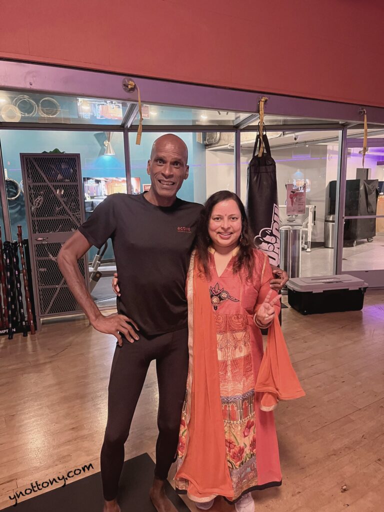 Crunch Fitness Yoga Class at 35o 3rd Street, San Francisco  Yoga teacher, tony Eason standing with yoga student.
